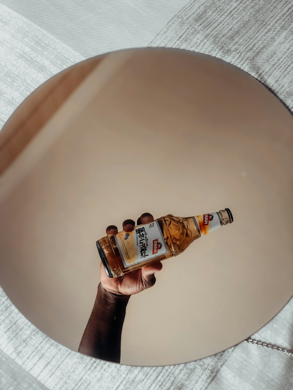 clear glass bottle on white round table