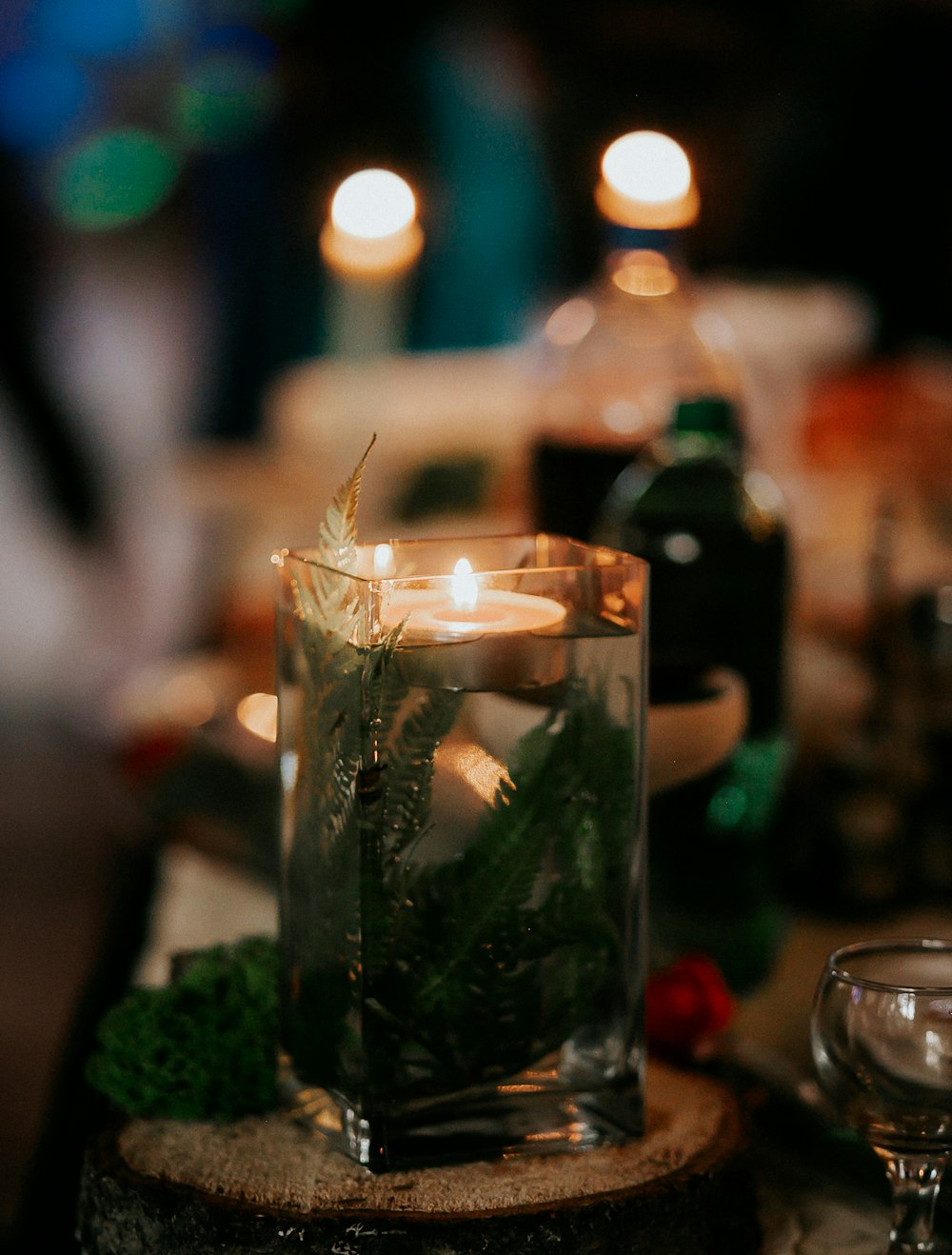 clear glass bottle with green plant