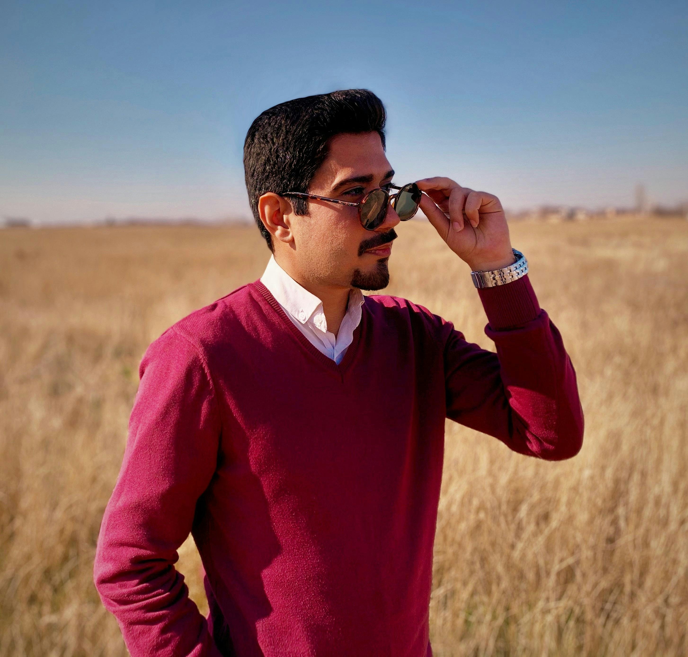 man in red sweater wearing black sunglasses