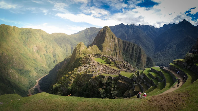 Visitors on the agricultural terraces above Machu Picchu, the citadel and peak behind