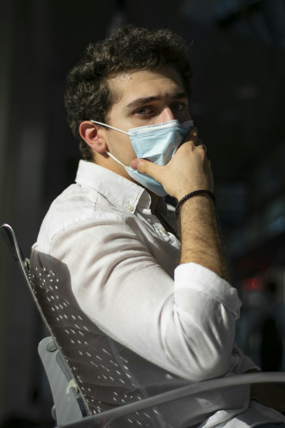 man in white dress shirt wearing white face mask