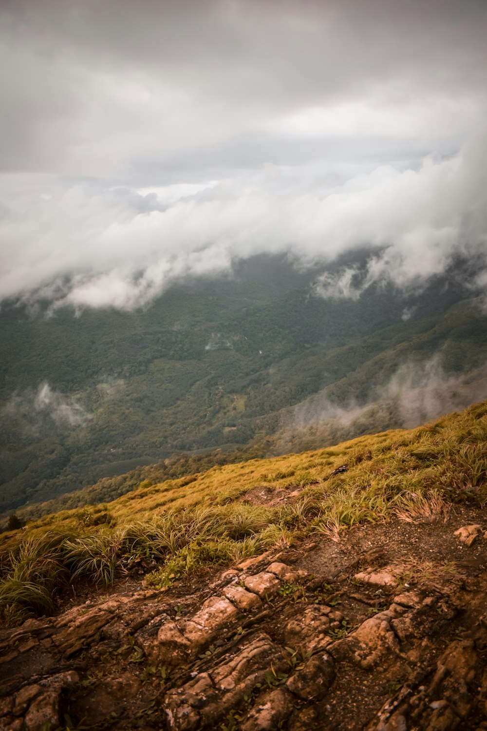 green and brown mountain under white clouds during daytime