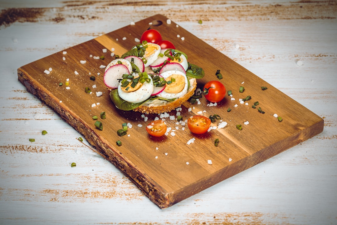 sliced cucumber and tomato on brown wooden chopping board