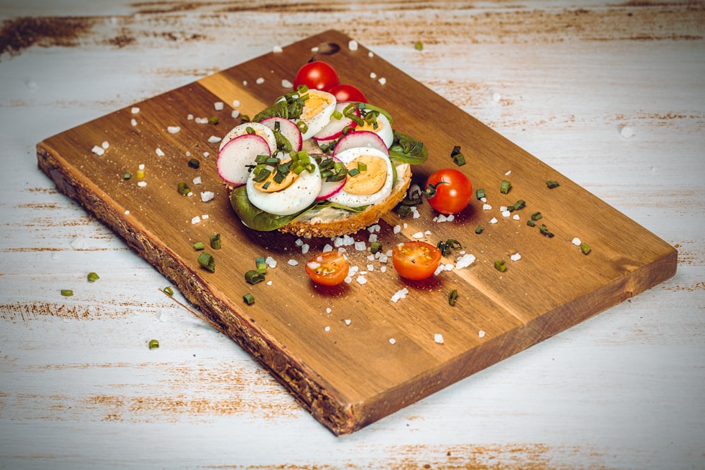sliced cucumber and tomato on brown wooden chopping board