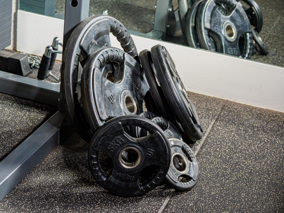 black and silver dumbbells on gray and white rug