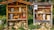 Two wooden structures resembling insect hotels are placed side by side outdoors. Each structure contains various natural materials like logs, sticks, and bricks with holes to provide shelter for insects. The structures are surrounded by lush greenery and flowers, creating a harmonious blend with the natural environment.