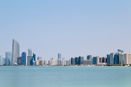 city skyline across body of water during daytime in Emirates Heritage Club Heritage Village United Arab Emirates