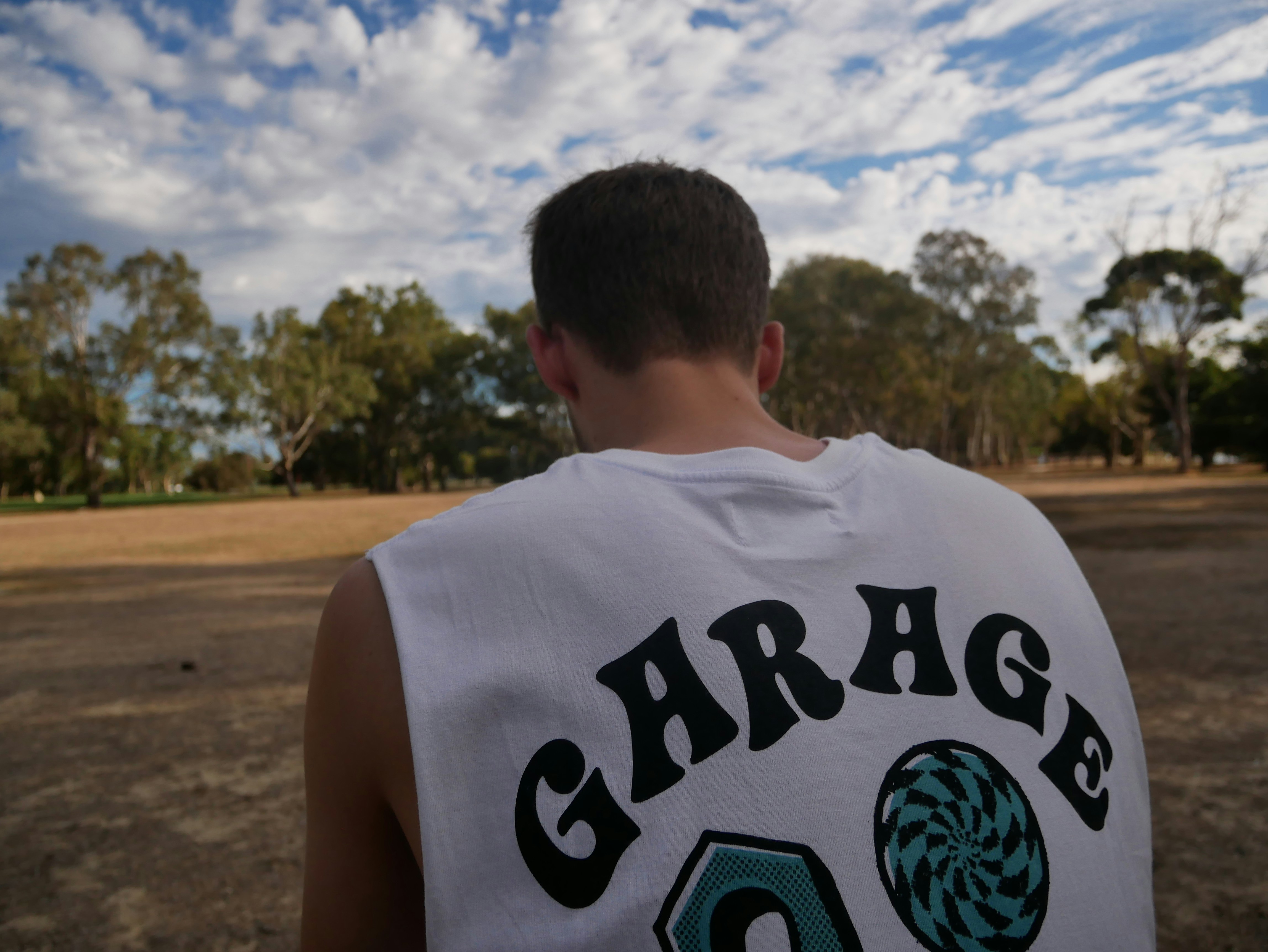 Urban style graphic T-shirt worn outdoors in natural daylight, bright open environment