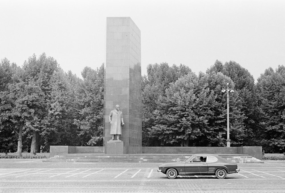 grayscale photo of classic car on road