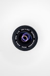 black camera lens on white surface