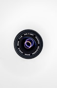 black camera lens on white surface