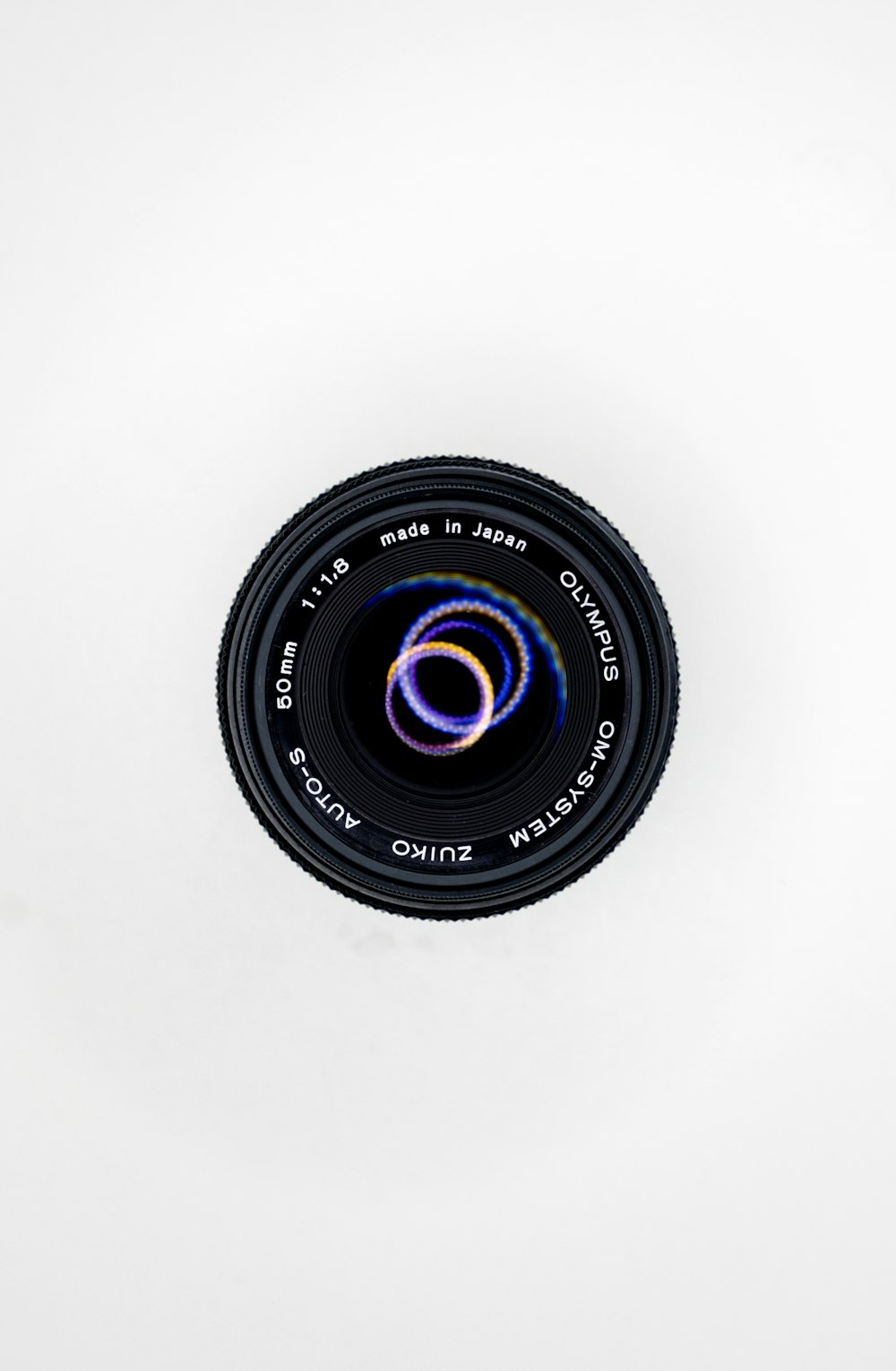 black camera lens on white surface