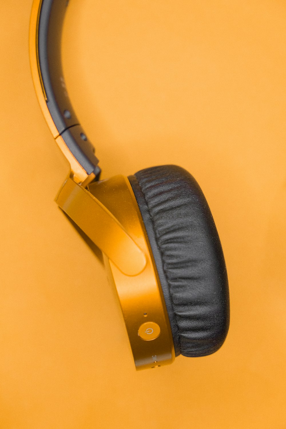 a pair of headphones sitting on top of a yellow surface