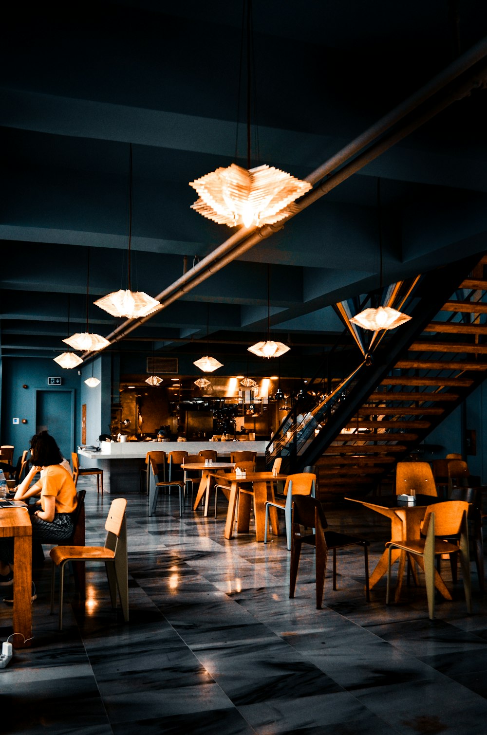 people sitting on chairs inside restaurant