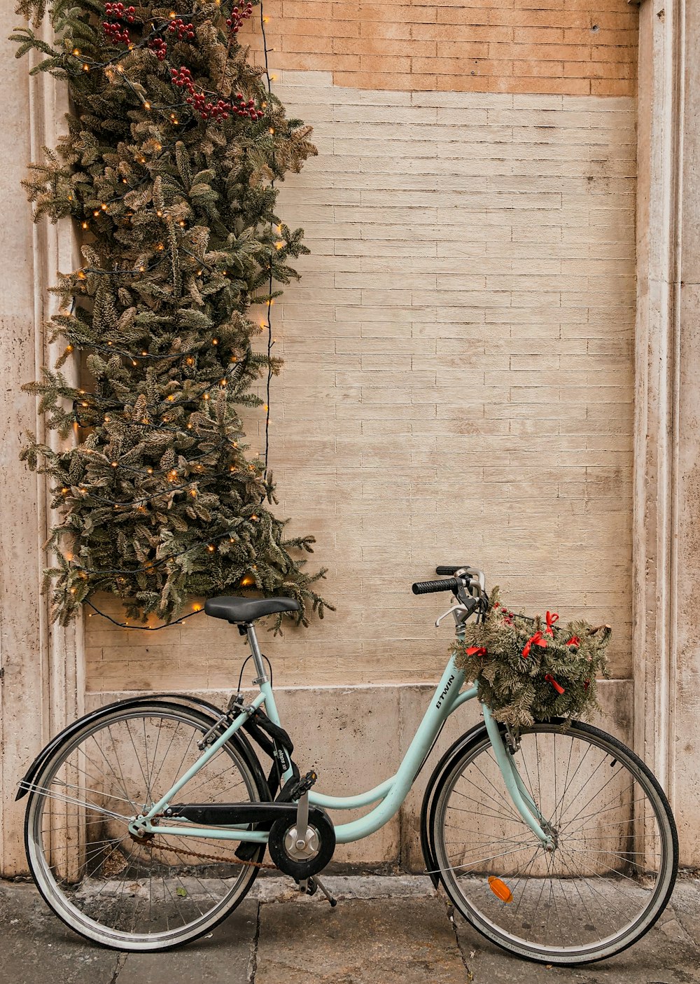 black city bike parked beside brown wall