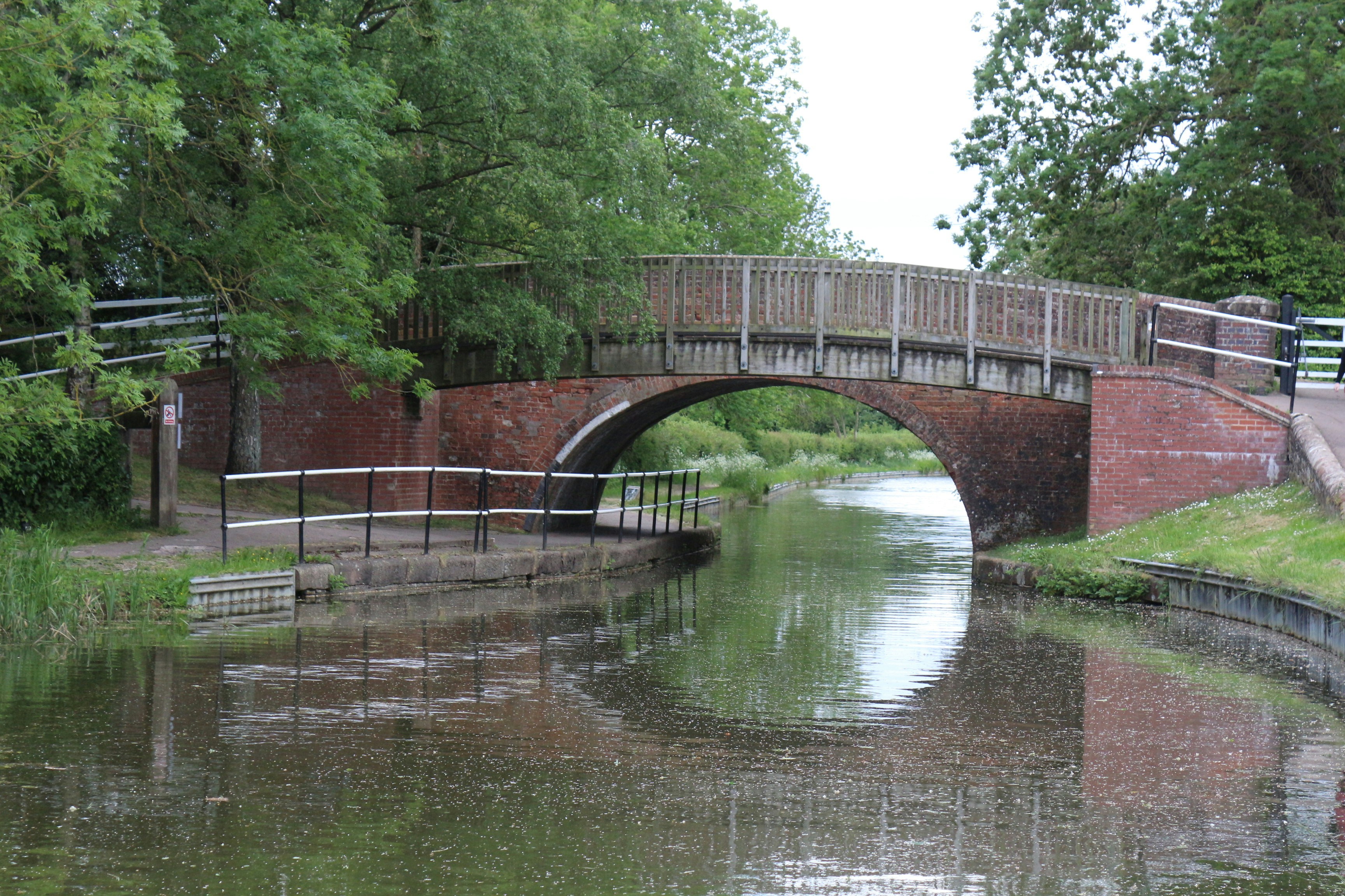 Canal bridge over a still body of water