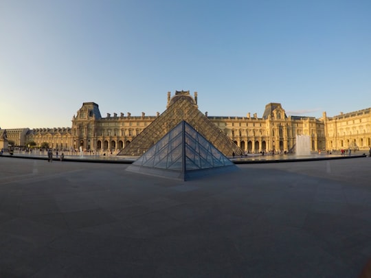 brown concrete building under blue sky during daytime in Louvre France