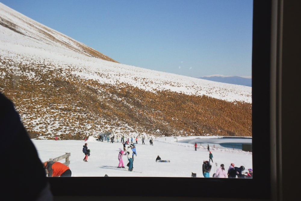 people walking on snow covered field during daytime