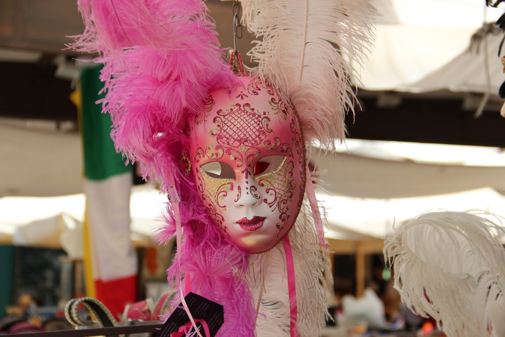 pink and white feather mask