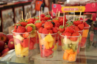 strawberries in clear plastic cups