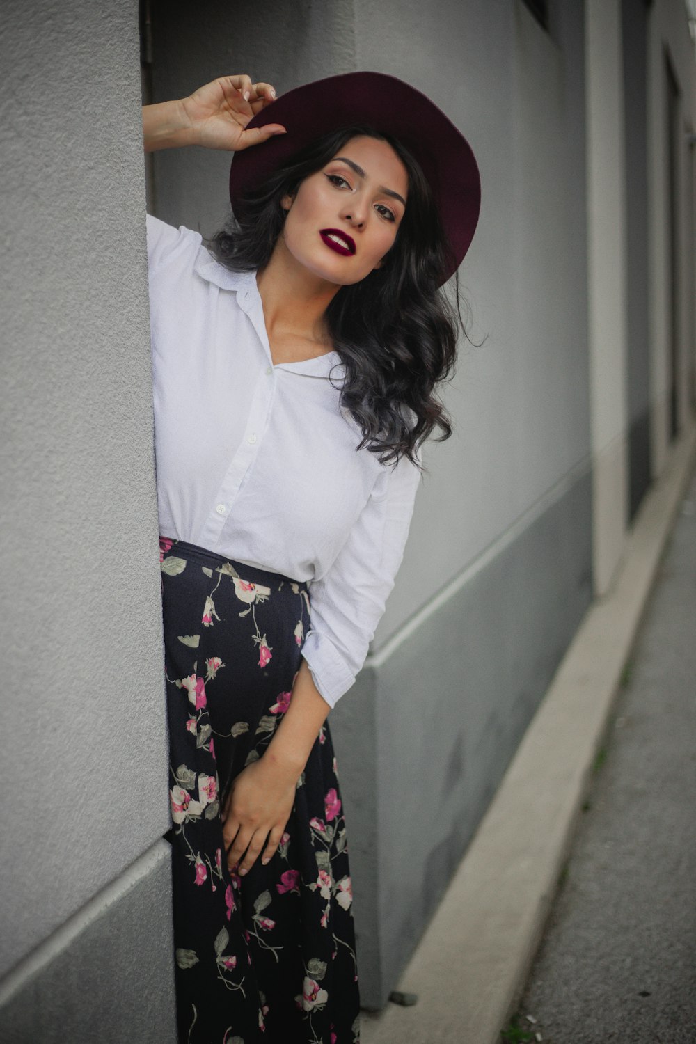 woman in white long sleeve shirt and black floral skirt