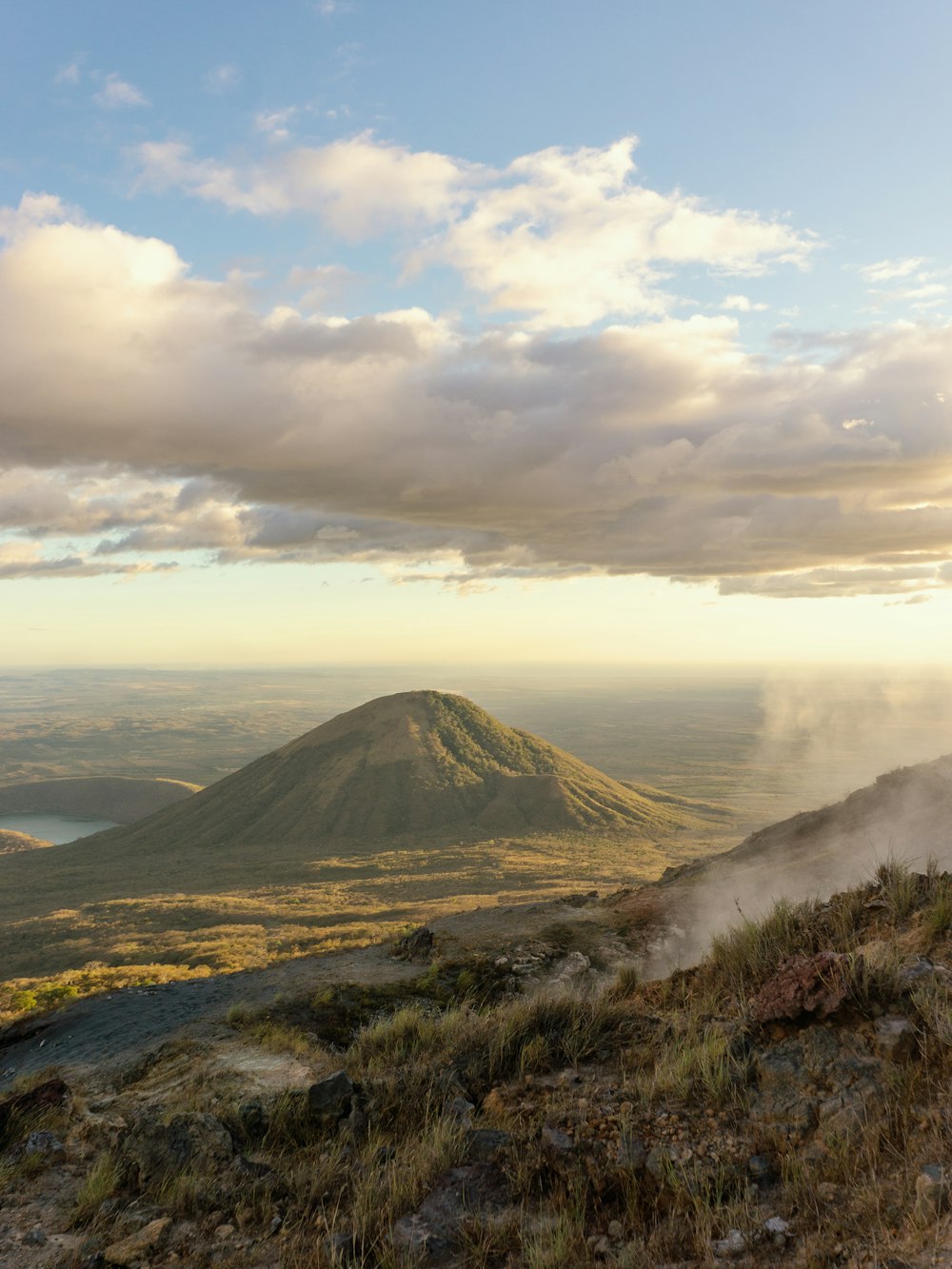 brown mountain under white clouds during daytime