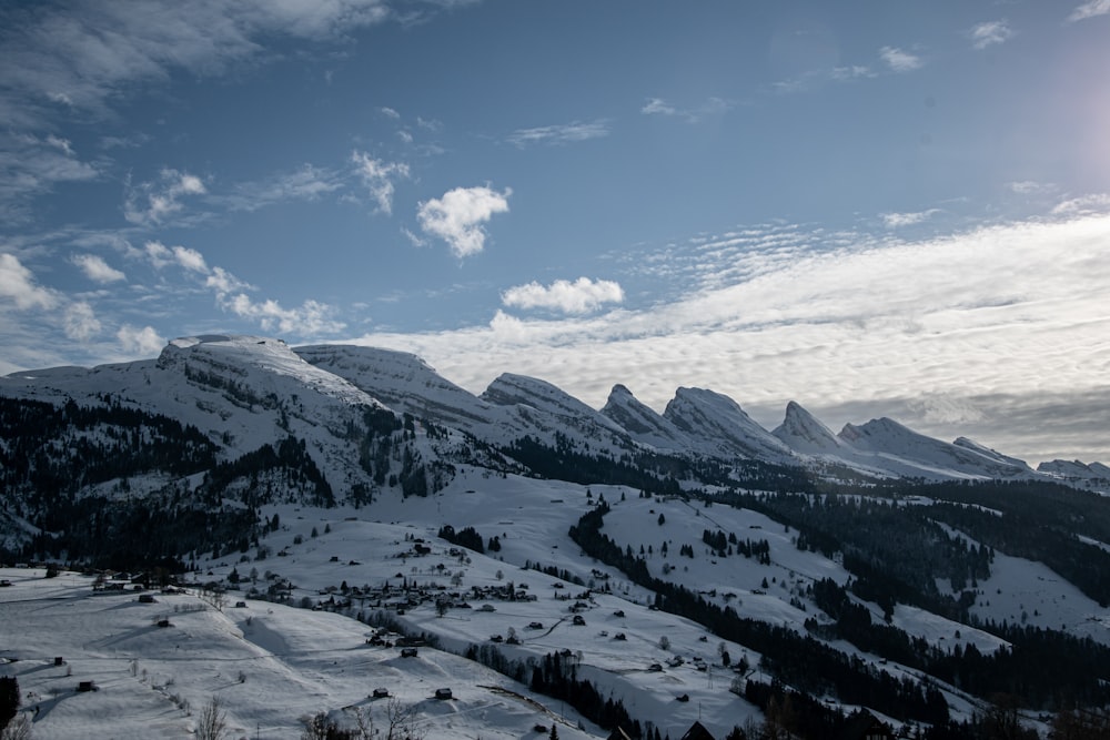 snow covered mountains under blue sky during daytime