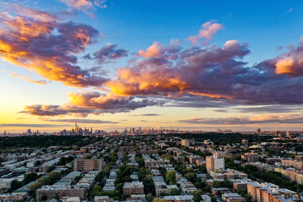 city with high rise buildings under blue and orange skies during sunset