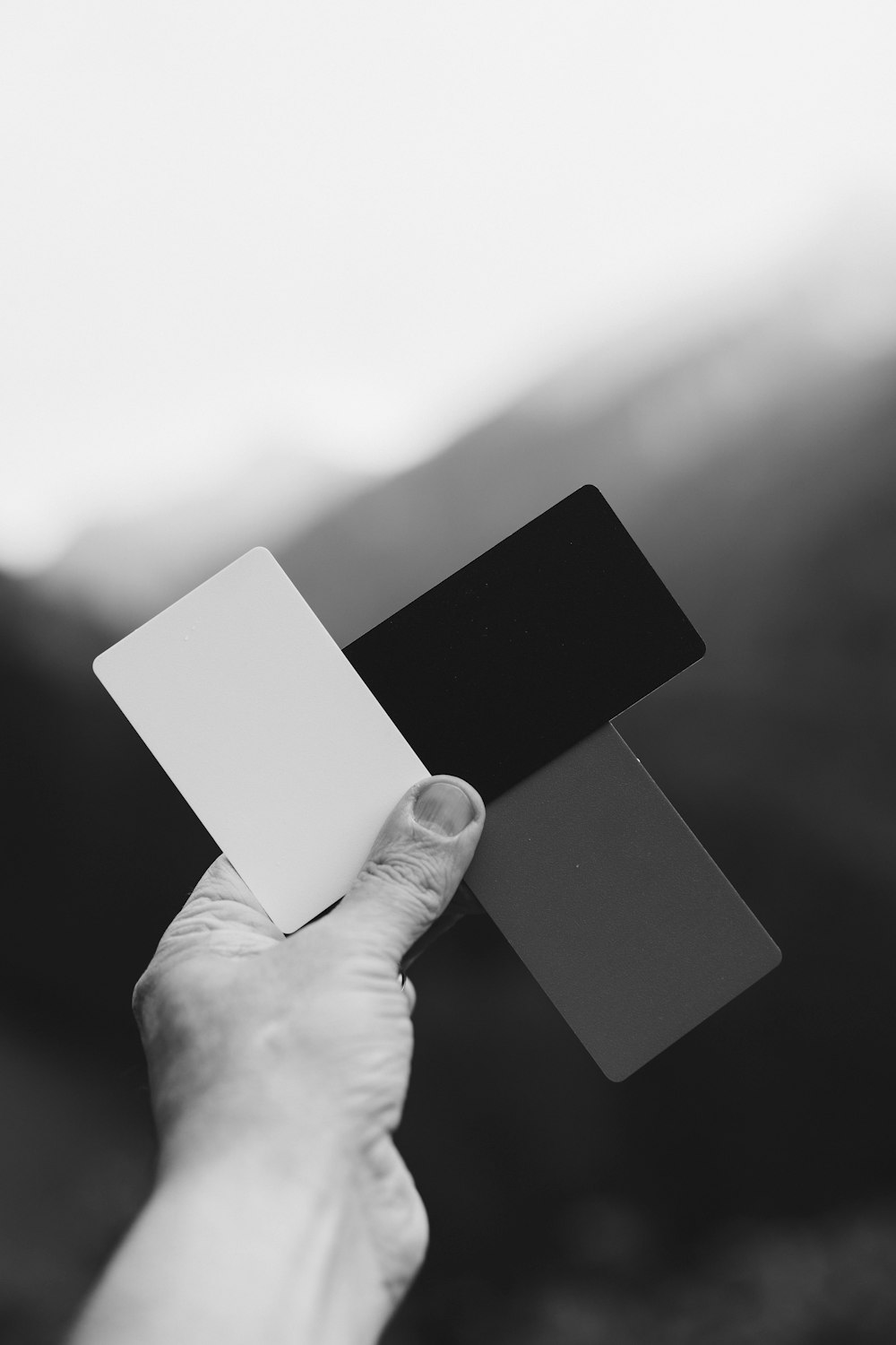 person holding white rectangular card