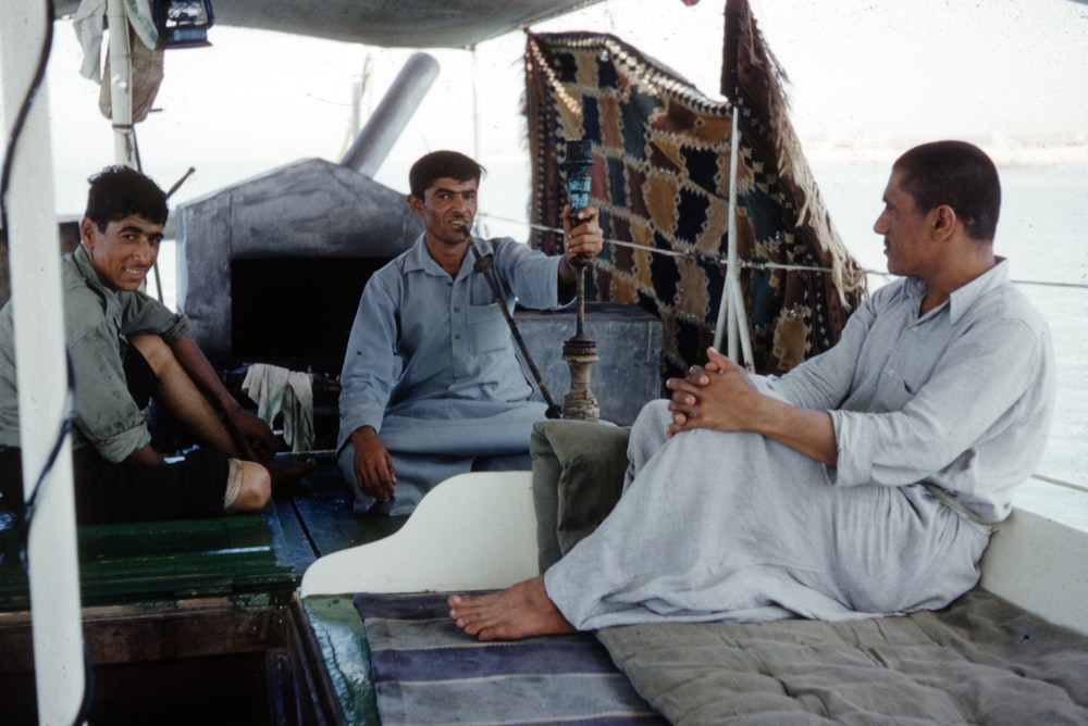 man in gray button up shirt sitting on bed