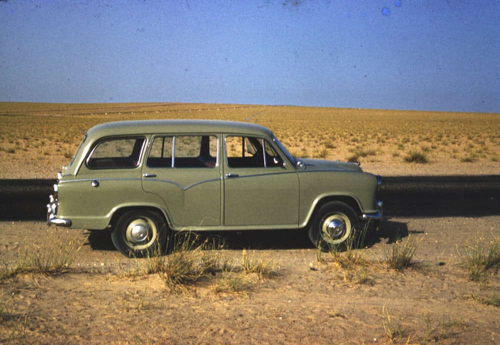 brown station wagon on brown field during daytime