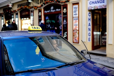 blue car in front of store