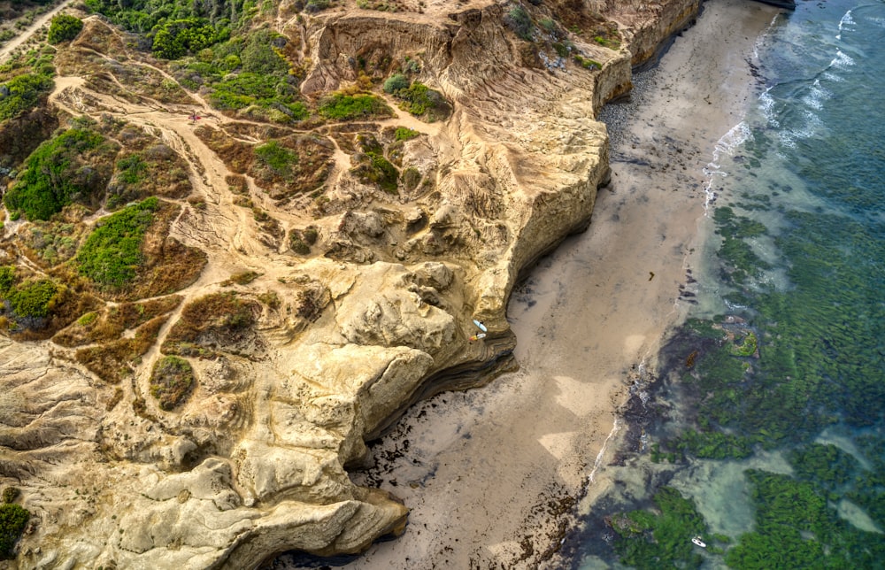 brown rock formation on body of water during daytime