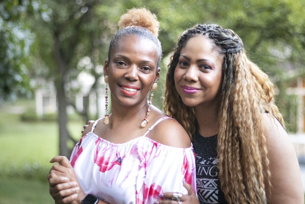 2 women smiling during daytime