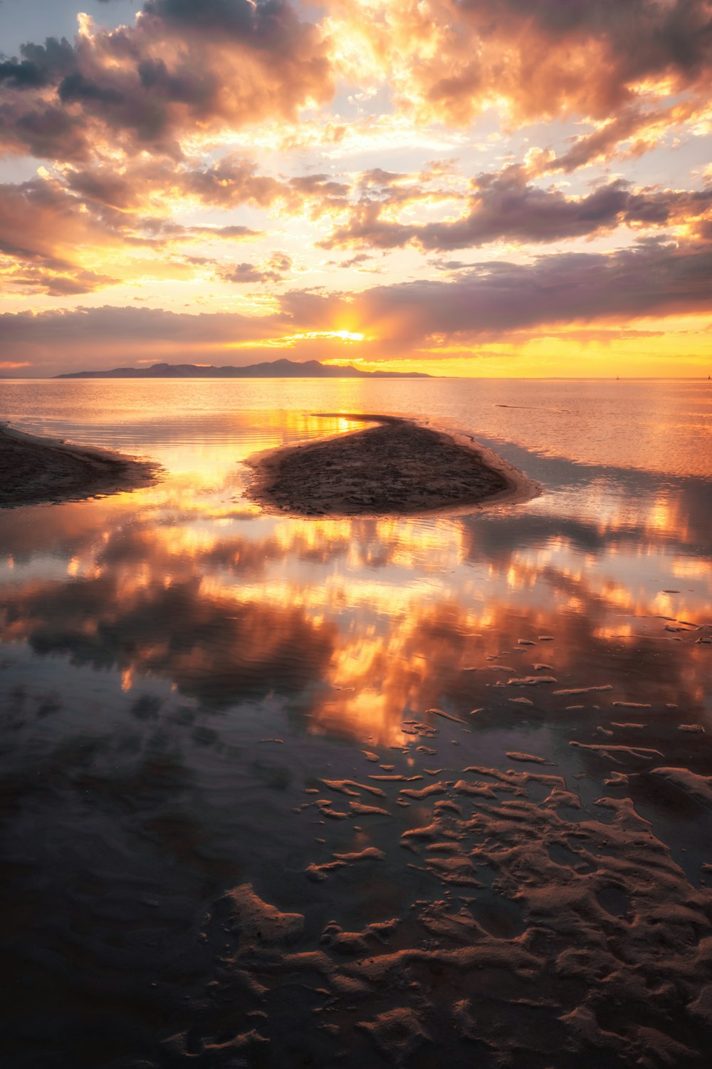 body of water under cloudy sky during sunset