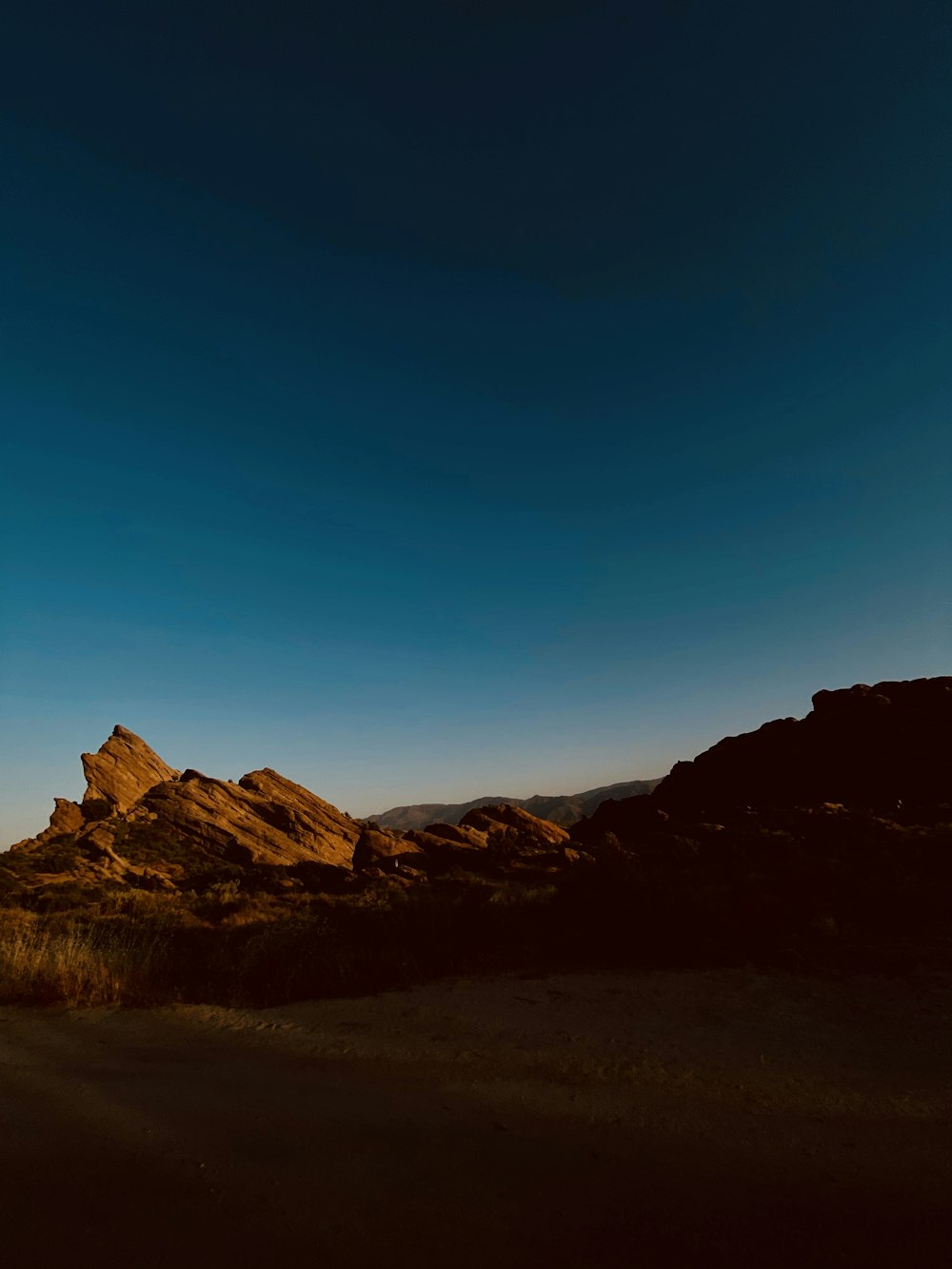 brown rocky mountain under blue sky during daytime