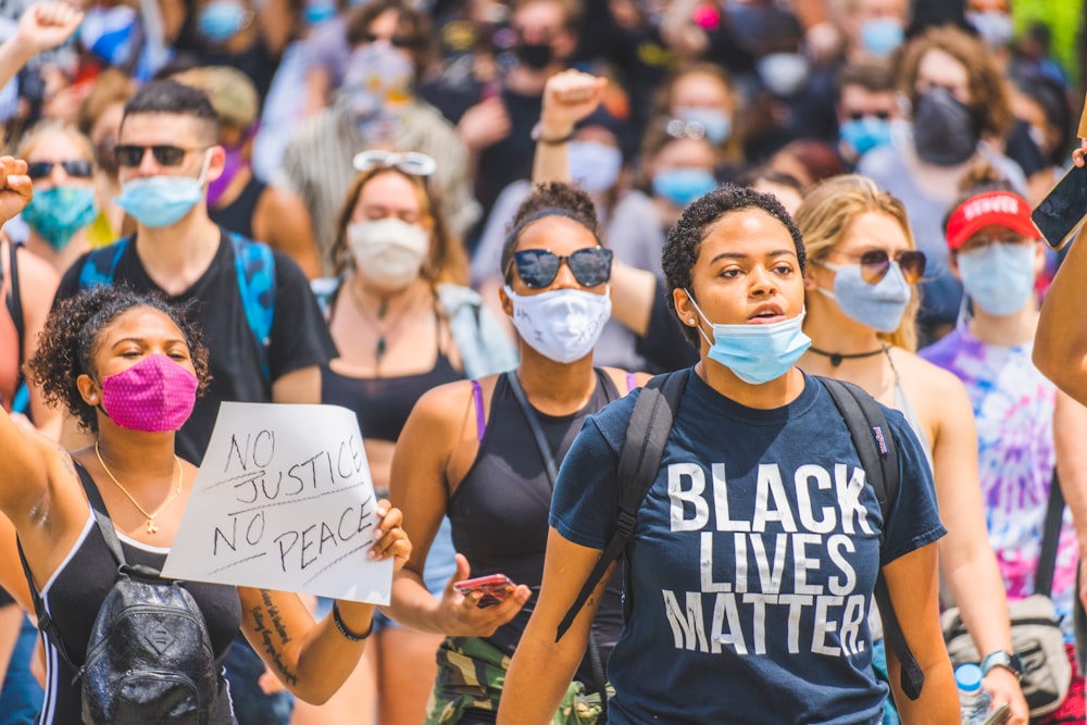 woman in black and white crew neck t-shirt wearing white mask