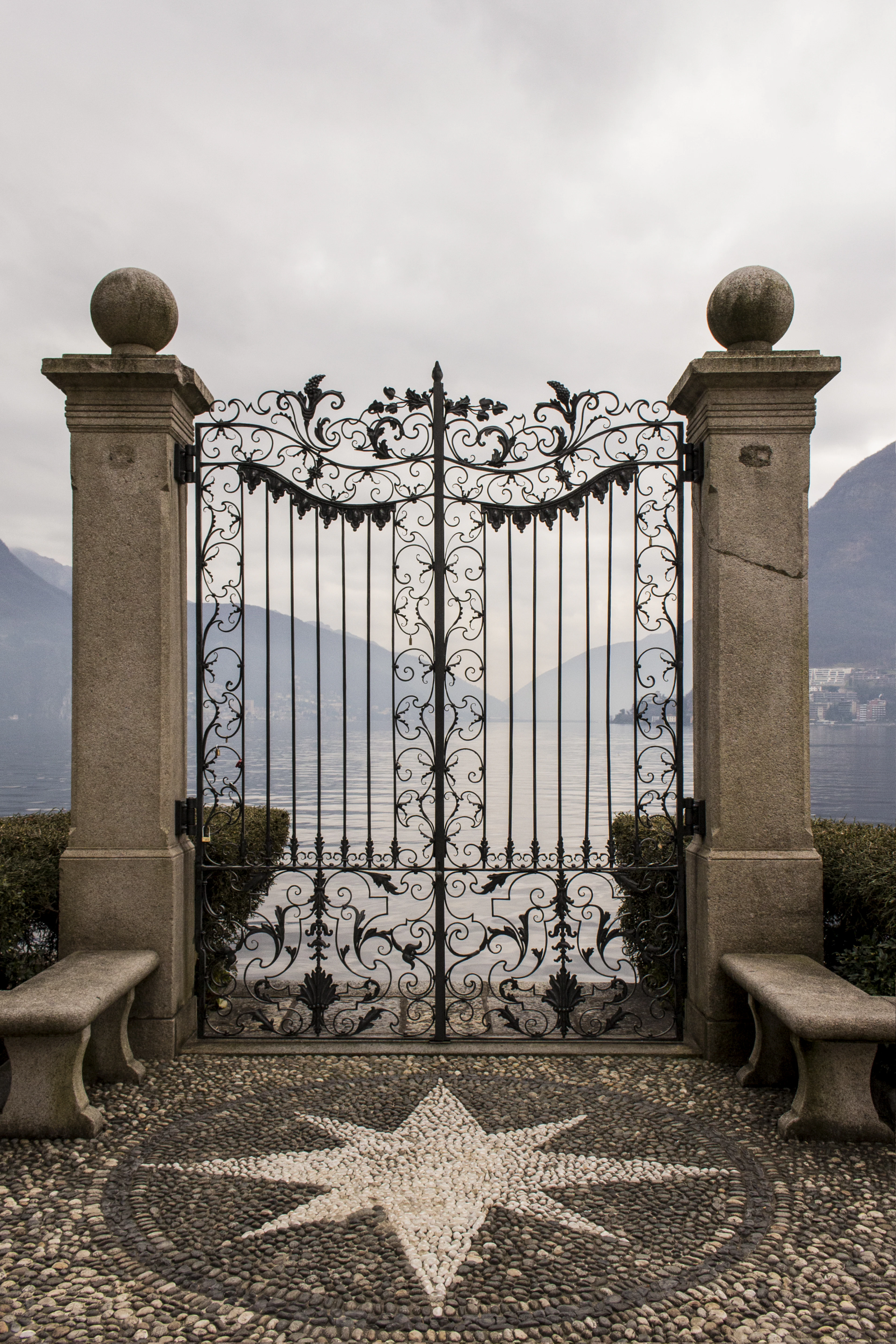 Black metal gate under a blue sky