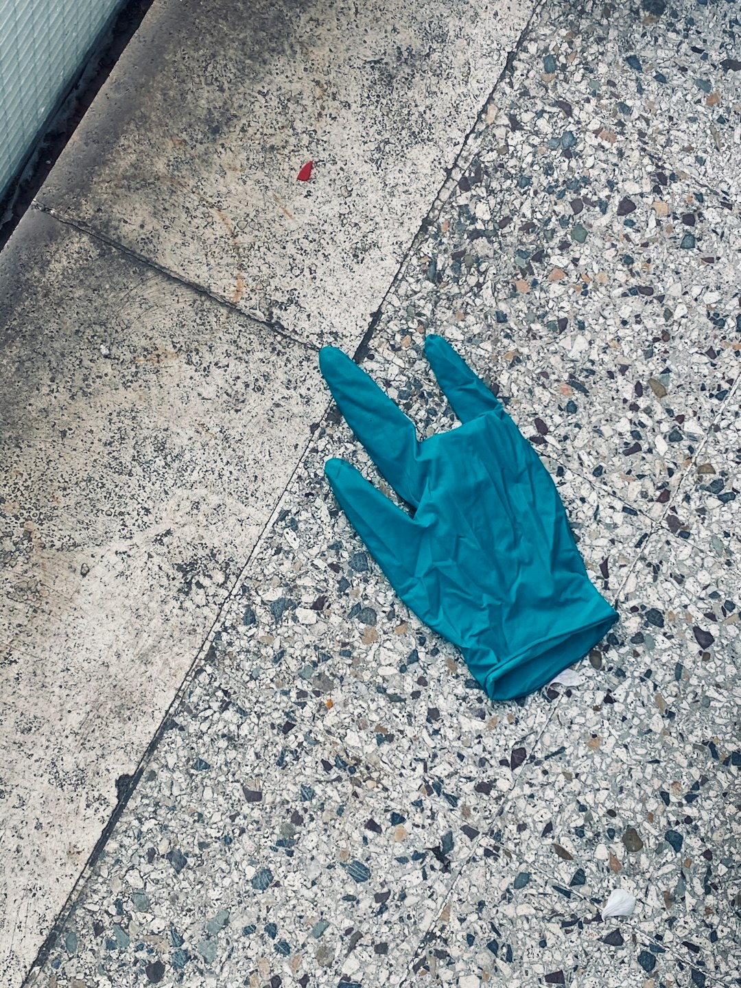 green plastic bag on gray concrete floor