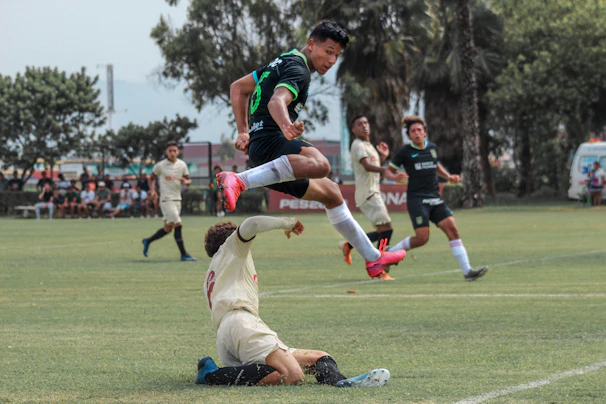 Dynamic shot of a player wearing a green national team jersey sprinting on the field