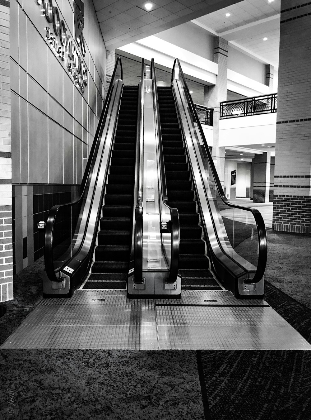 grayscale photo of a escalator