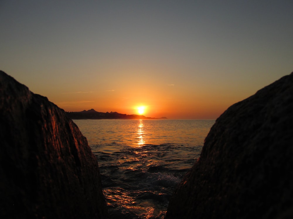 body of water during sunset