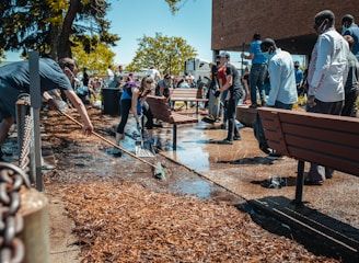 people sitting on brown wooden bench during daytime