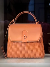 brown leather handbag on brown wooden table