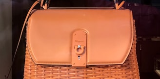brown leather handbag on brown wooden table