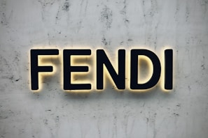 the word fendi spelled with neon lights on a wall