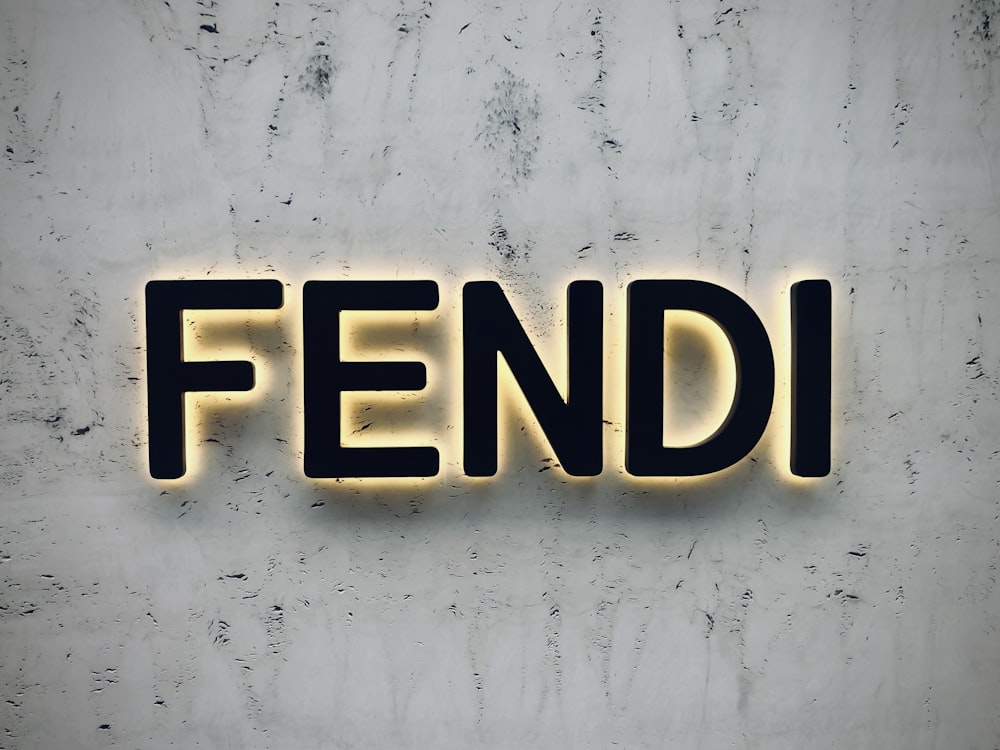 the word fendi spelled with neon lights on a wall