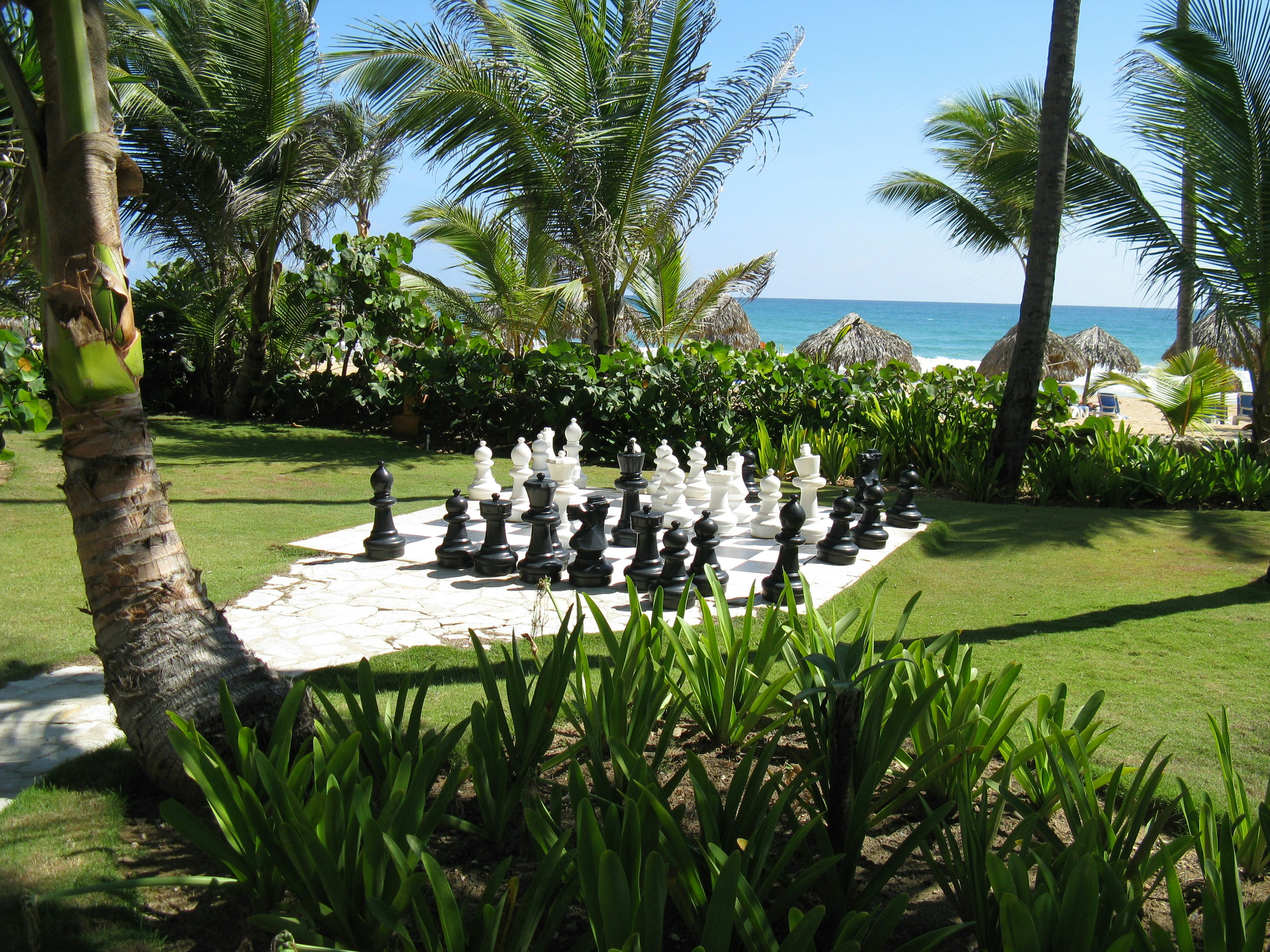 giant-sized chess set by the beach