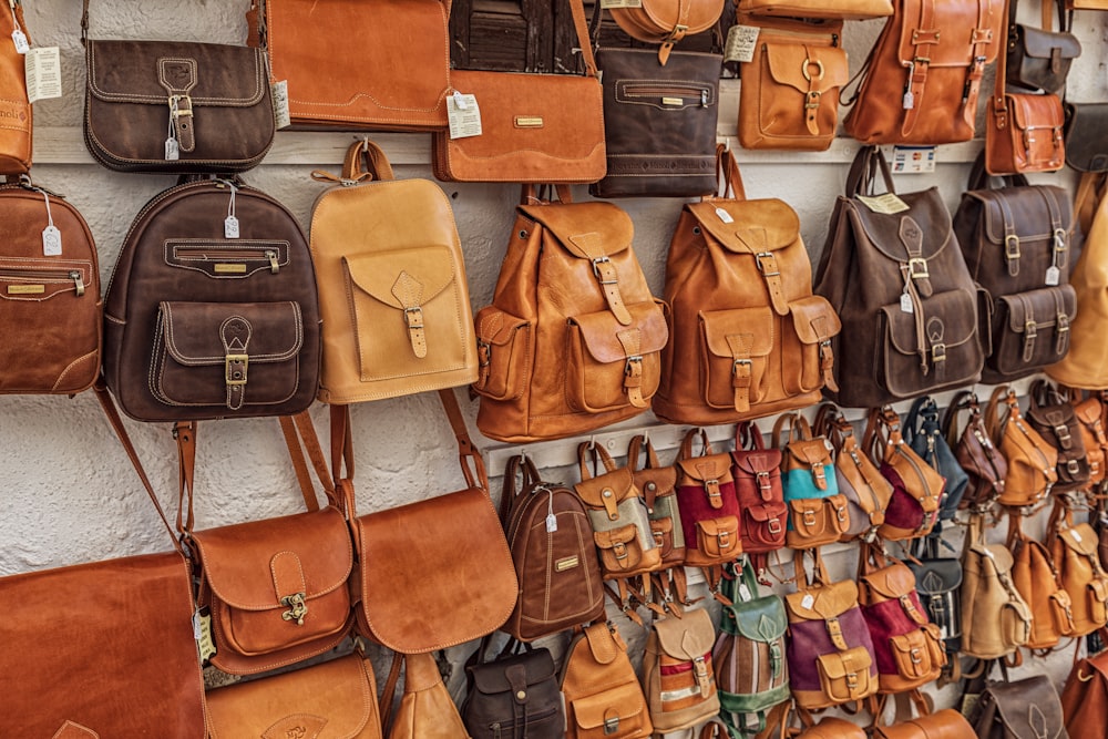 brown leather sling bag on brown wooden table