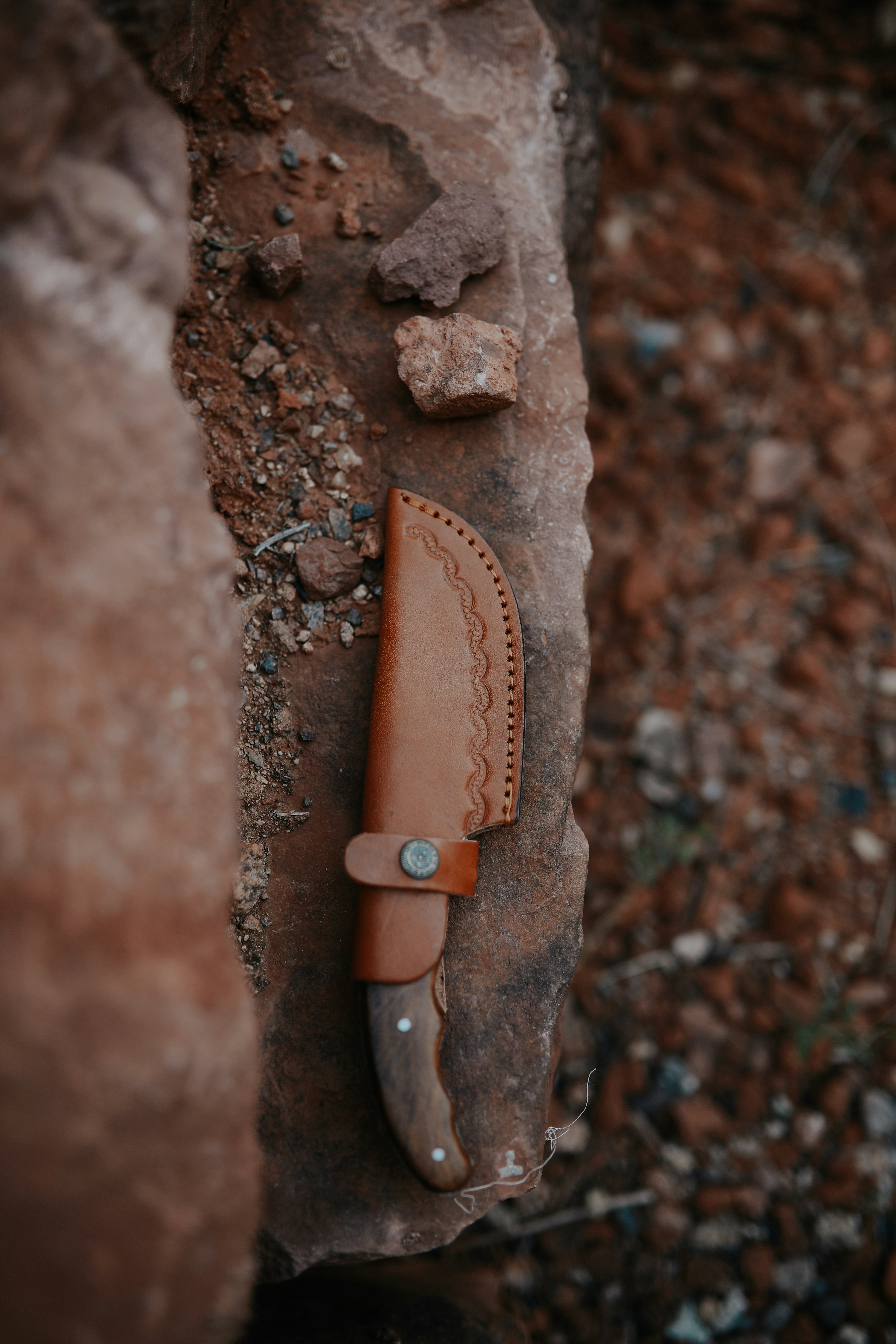 brown and silver knife on brown rock
